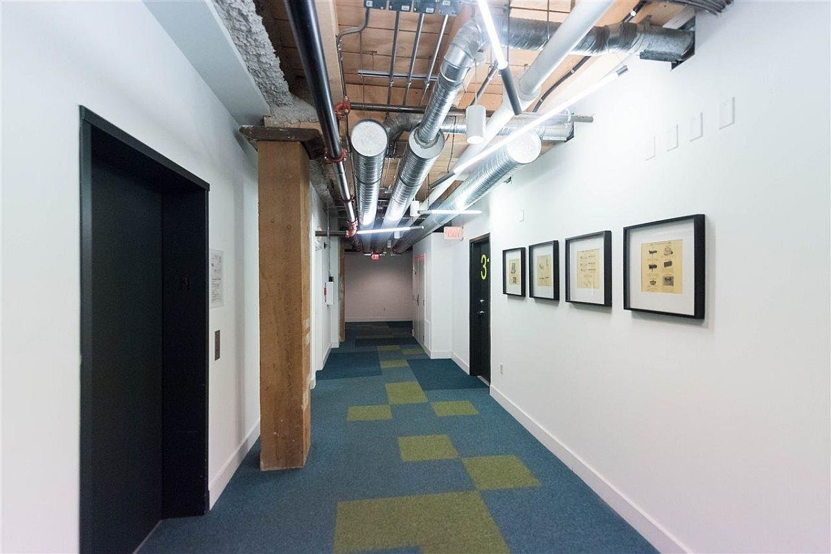 Exposed duct pipes inside the converted loft building