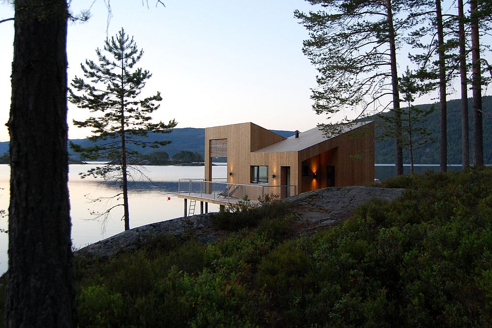 Cabin on stilts on water’s edge in Norway