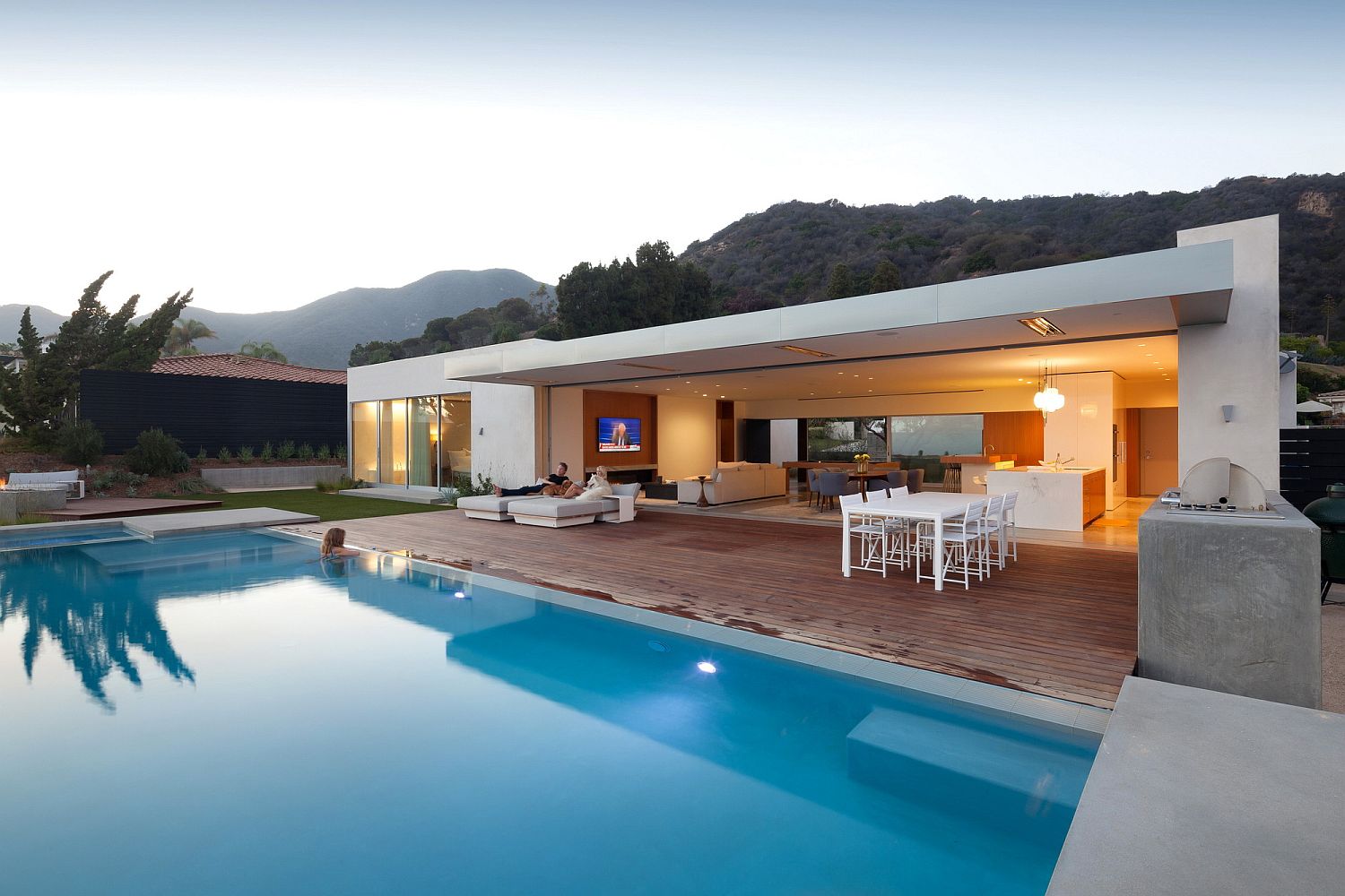 Open living area of the Los Angeles home connected with the deck and pool outside