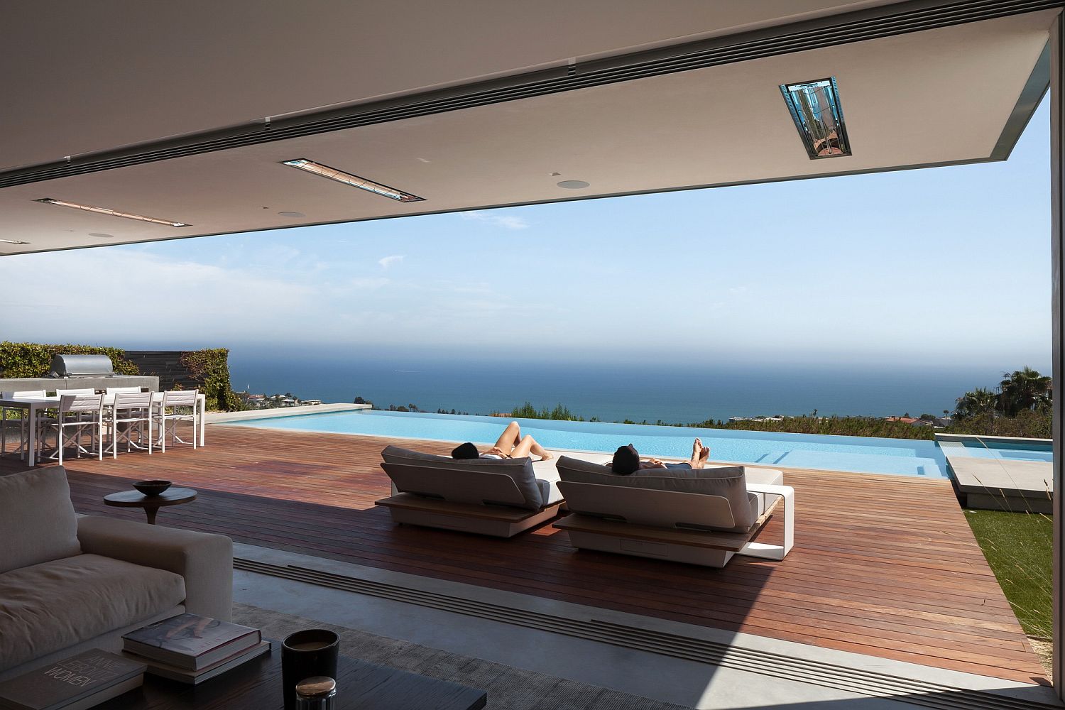 Spacious wooden deck next to the infinity pool overlooking the Pacific Ocean