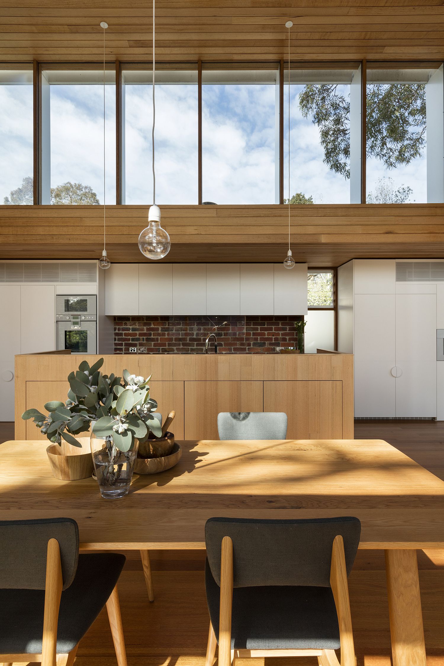 Simple and unassuming lights for the double height dining room