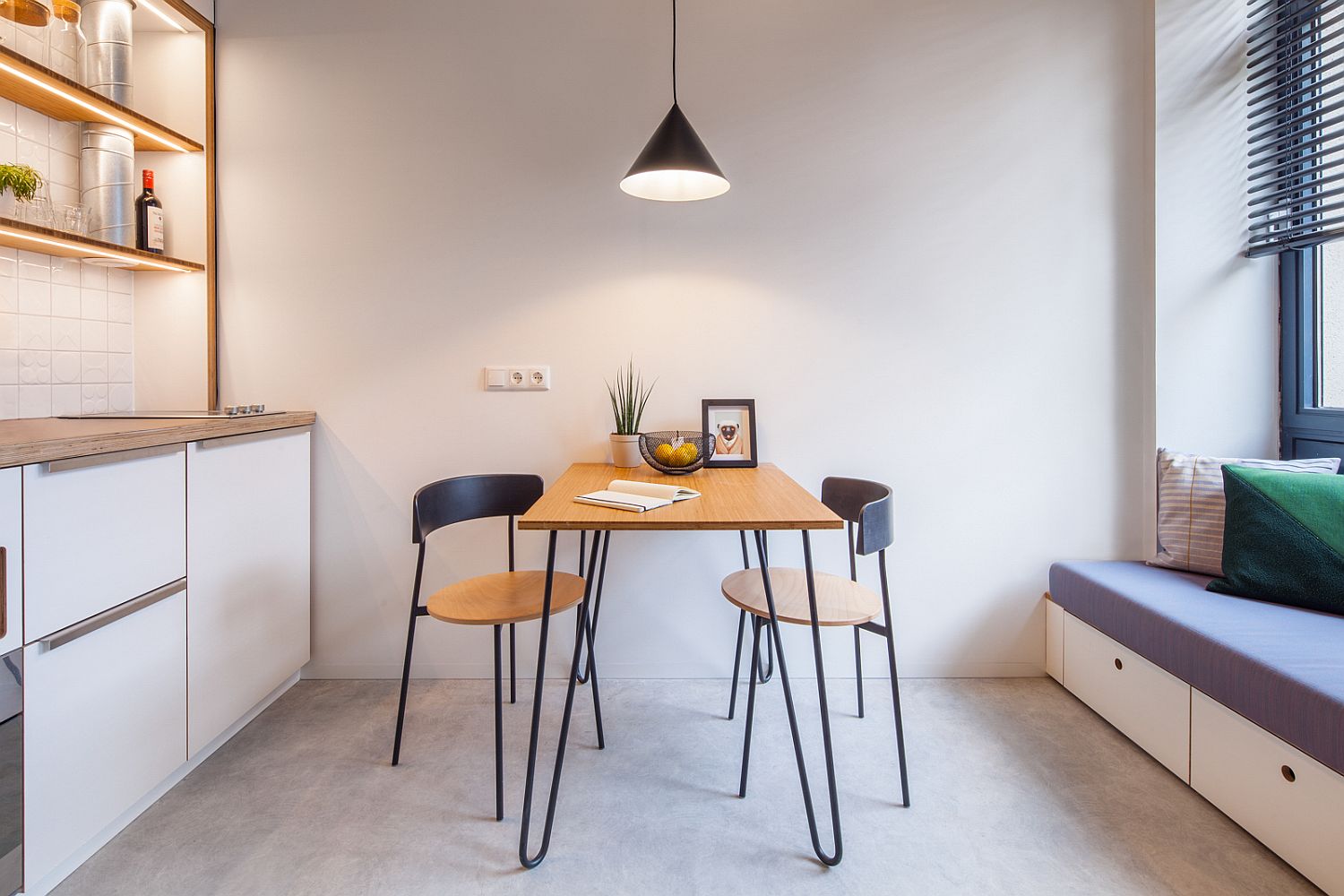 Tiny dining area between the small living area nook and the kitchen