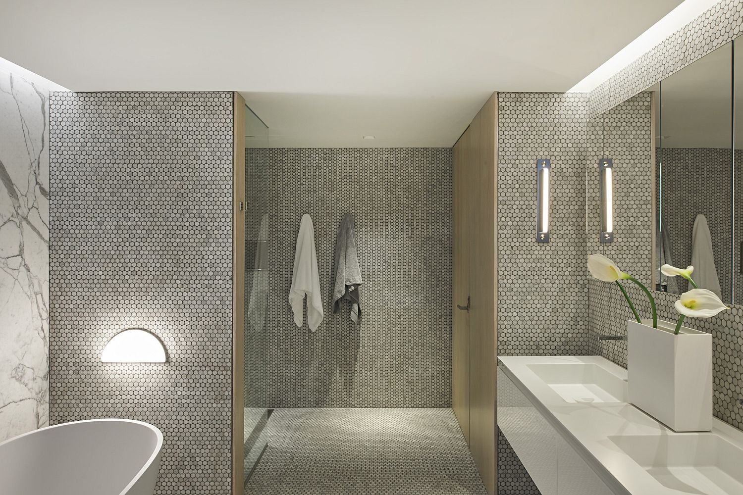 Marble and penny-tile clad gorgeous contemporary bathroom
