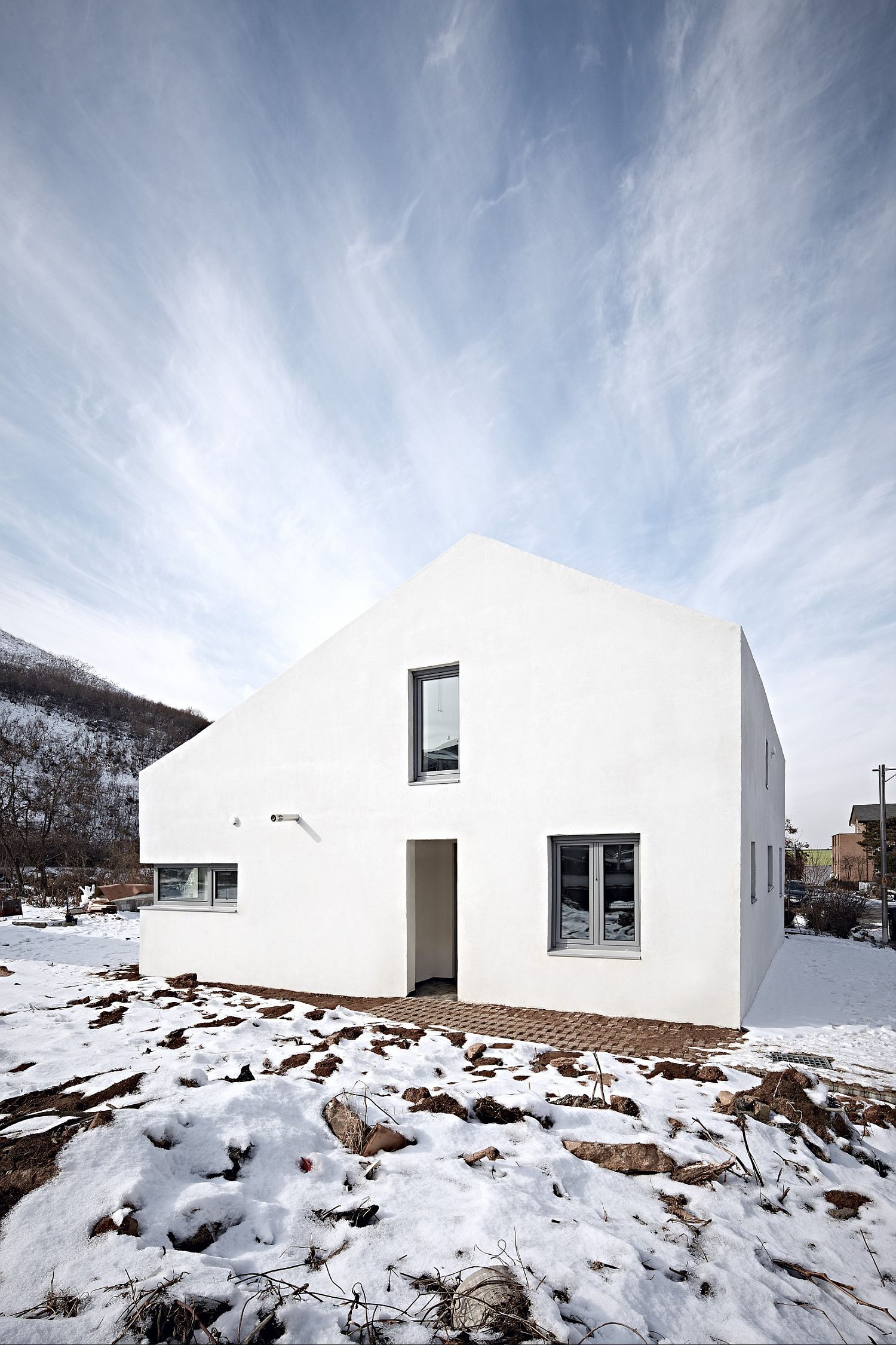 White exterior of the house blends into the backdrop