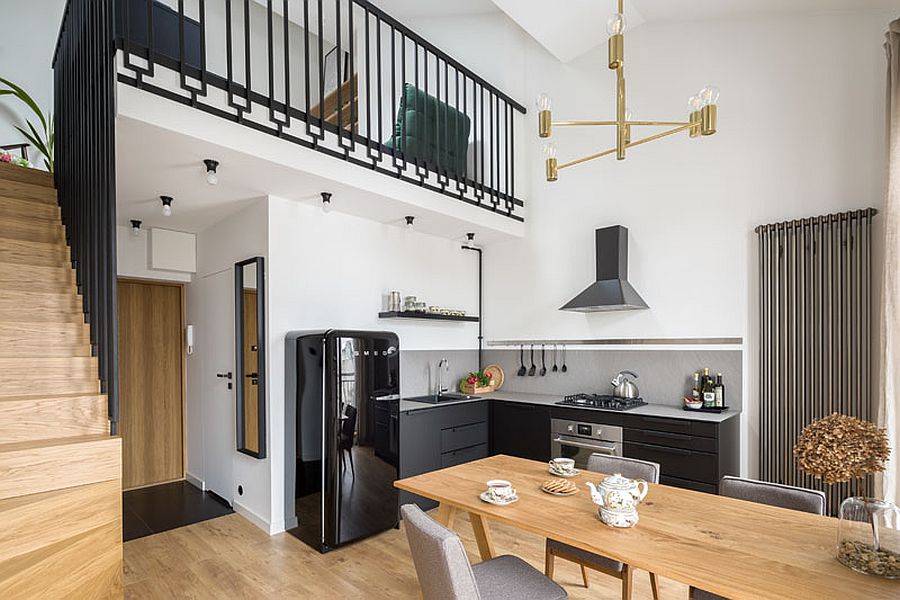 Wood and steel staircase leads to the mezzanine level above