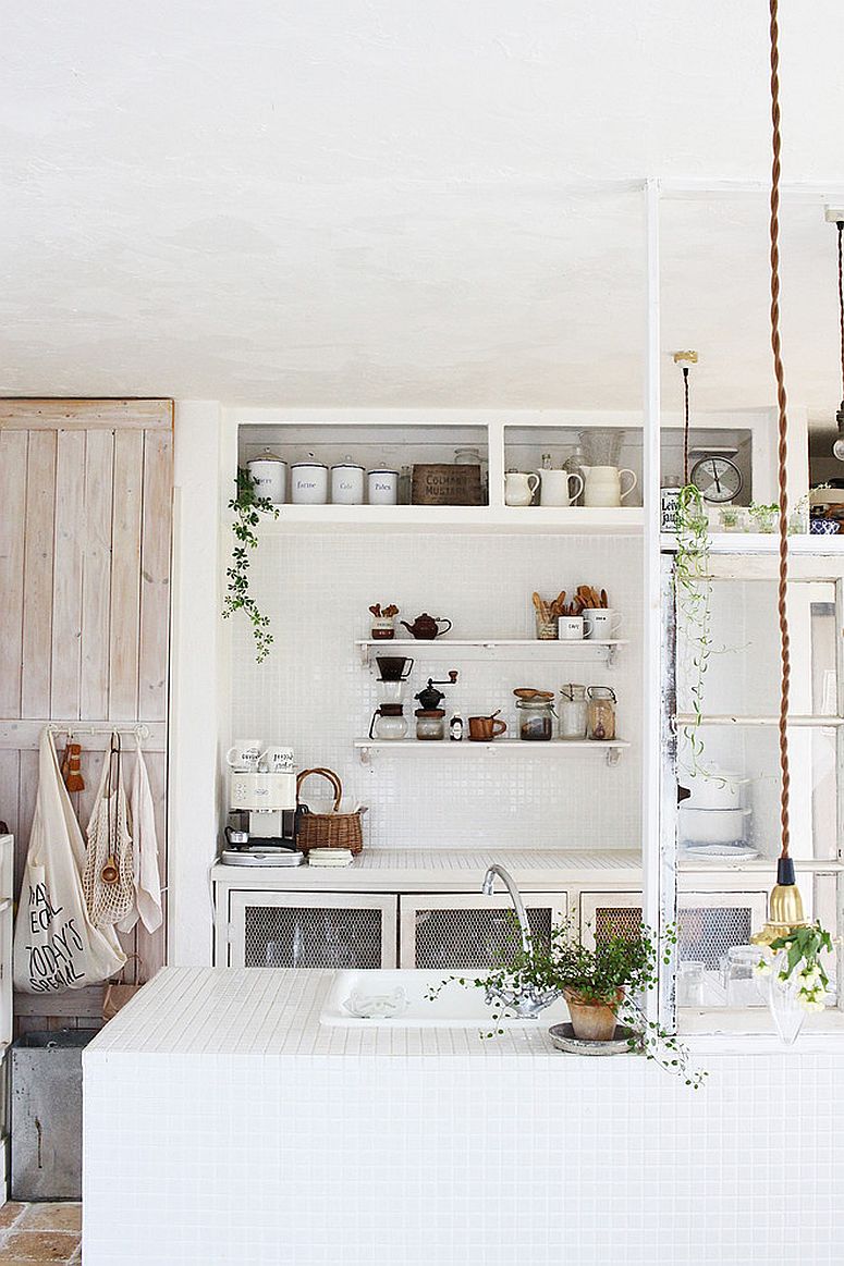 All-white shabby chic kitchen with plenty of natural greenery