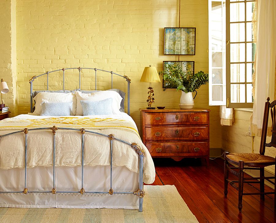 Painting the brick wall yellow gives the bedroom a different look!