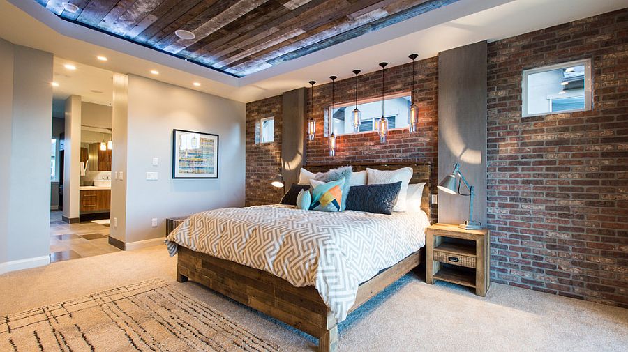 Reclaimed wood ceiling brings even more textural charm to the brick walled bedroom