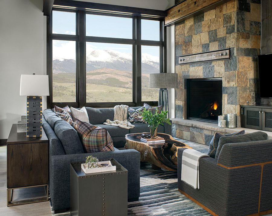 Stunning rustic living room with stone fireplace and a view to match