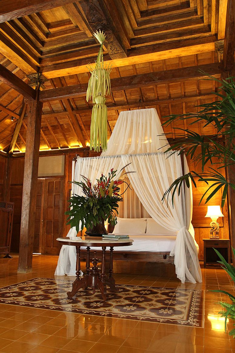 Using the sheer to decorate the four-poster bed and turn it into a canopy bed