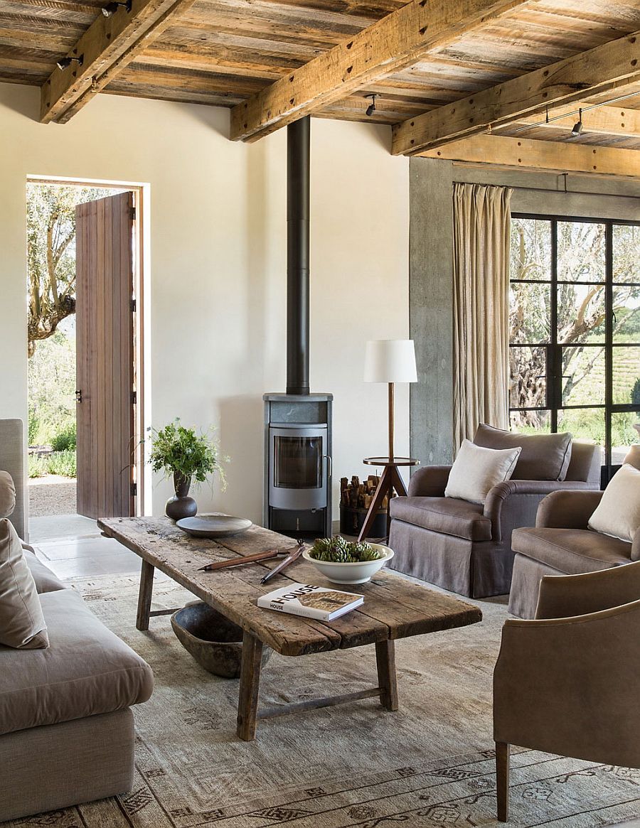 Wooden coffee table, ceiling beams and fireplace add rustic beauty to the living room