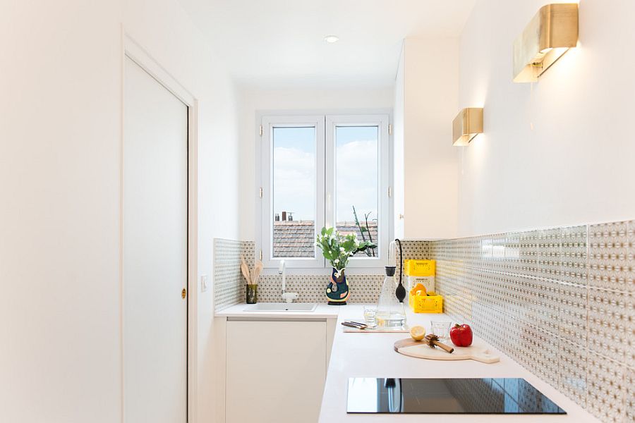 Innovative use of sconce lights in the tiny white kitchen
