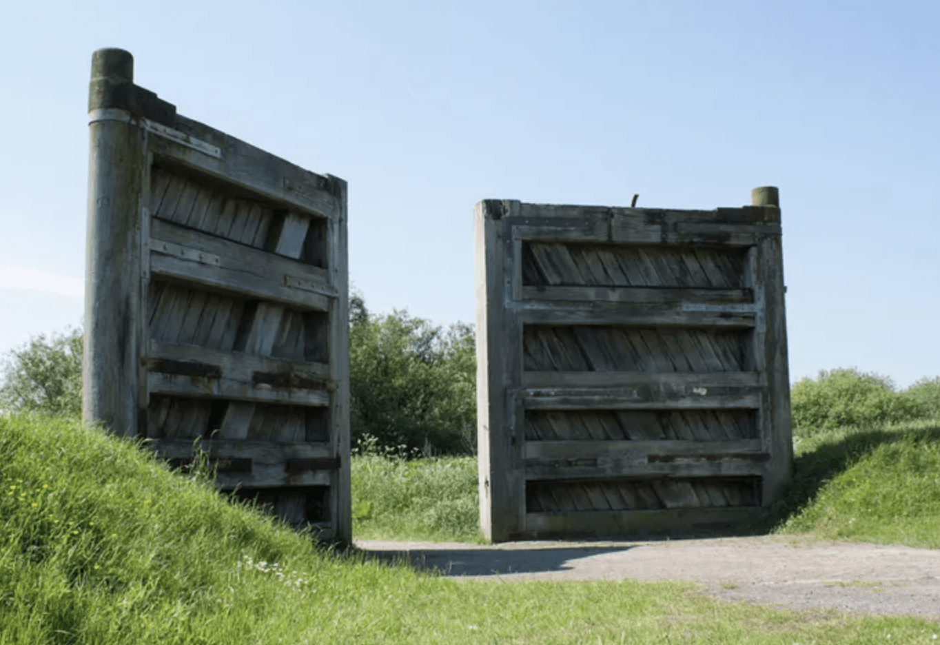 large oversized wooden gates leading out into green space